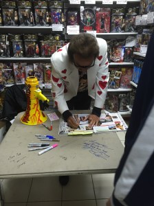Jimmy signing his entries in the WWE Encyclopedia, Volume II. 