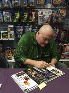 King Kong Bundy signing his entry in the WWE Encyclopedia, Vol. 2
